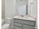 Clean bathroom with grey vanity, quartz countertop and a bathtub at 1209 Kistna Dr, Zephyrhills, FL 33540