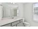 Modern bathroom with gray vanity and quartz countertop at 1209 Kistna Dr, Zephyrhills, FL 33540