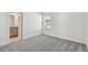 Bedroom with grey carpet and access to bathroom at 1209 Kistna Dr, Zephyrhills, FL 33540