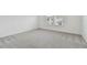 Spacious bedroom with grey carpeting and ample natural light at 1209 Kistna Dr, Zephyrhills, FL 33540