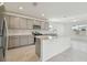 Open kitchen boasts a large island and grey cabinetry at 1209 Kistna Dr, Zephyrhills, FL 33540