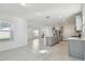 Open floor plan showing kitchen with island and stainless steel appliances at 1209 Kistna Dr, Zephyrhills, FL 33540