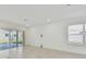 Bright and airy living room with sliding glass doors and tile flooring at 1209 Kistna Dr, Zephyrhills, FL 33540