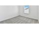 Bright bedroom with grey carpet and window at 1185 Kistna Dr, Zephyrhills, FL 33540