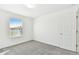 Bright bedroom with gray carpet and a window at 1185 Kistna Dr, Zephyrhills, FL 33540