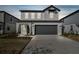 Two-story home with dark grey garage door at 1185 Kistna Dr, Zephyrhills, FL 33540