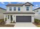Two-story house with gray garage door and white accents at 1185 Kistna Dr, Zephyrhills, FL 33540