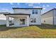 Two-story house with covered patio and grassy backyard at 1185 Kistna Dr, Zephyrhills, FL 33540