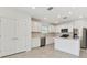 Modern kitchen with white cabinets, island, and stainless steel appliances at 1185 Kistna Dr, Zephyrhills, FL 33540