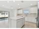 Open concept kitchen with island and access to backyard at 1185 Kistna Dr, Zephyrhills, FL 33540