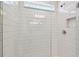 Clean shower with subway tile and glass enclosure at 1185 Kistna Dr, Zephyrhills, FL 33540