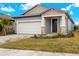New construction home with two-car garage and attractive landscaping at 3782 Maxwell Park Dr, Sun City Center, FL 33573