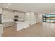 Open concept kitchen with island and view to backyard at 3782 Maxwell Park Dr, Sun City Center, FL 33573