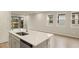 Open concept kitchen with island, stainless steel appliances, and view to backyard at 3782 Maxwell Park Dr, Sun City Center, FL 33573