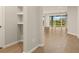 Bright entryway with tile flooring and built-in shelving leading to the living area at 11680 Myakka Blue Dr, Venice, FL 34293