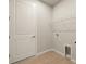 Laundry room with wire shelving, a door, and a utility sink at 11680 Myakka Blue Dr, Venice, FL 34293