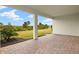 Covered patio with brick pavers and a view of the backyard at 11680 Myakka Blue Dr, Venice, FL 34293