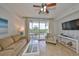 Relaxing living room featuring comfortable seating and access to a private balcony at 3226 Mangrove Point Dr, Ruskin, FL 33570