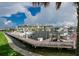 Boats docked at a marina with a wooden walkway and buildings in the background at 3226 Mangrove Point Dr, Ruskin, FL 33570