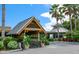 Entrance to a waterfront restaurant with lush tropical landscaping and a metal roof at 3226 Mangrove Point Dr, Ruskin, FL 33570