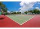 Two well-maintained tennis courts with red and green surfaces at 3226 Mangrove Point Dr, Ruskin, FL 33570