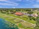 Community clubhouse and golf course with scenic pond and landscape at 30805 Satinleaf Run, Brooksville, FL 34602