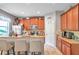 Modern kitchen with wood cabinets, granite countertops, and island with seating at 30805 Satinleaf Run, Brooksville, FL 34602