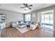 Spacious living room with sectional sofa, large windows, and sliding glass doors at 30805 Satinleaf Run, Brooksville, FL 34602