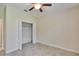 Simple bedroom with ceiling fan and double door closet at 11612 Mansfield Point Dr, Riverview, FL 33569