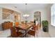 Elegant dining room featuring a wood table, leather chairs, and ample natural light at 11612 Mansfield Point Dr, Riverview, FL 33569