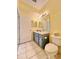 Bathroom with double vanity, toilet, and tiled floor at 761 Tremont Greens Ln # 61, Sun City Center, FL 33573