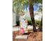 Landscaped front yard with palm trees and garden flag at 761 Tremont Greens Ln # 61, Sun City Center, FL 33573