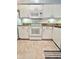 White kitchen with granite countertops and appliances at 761 Tremont Greens Ln # 61, Sun City Center, FL 33573