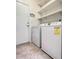 Laundry room with washer, dryer, and shelving at 761 Tremont Greens Ln # 61, Sun City Center, FL 33573