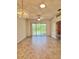 Bright living room with ceiling fan and chandelier at 761 Tremont Greens Ln # 61, Sun City Center, FL 33573