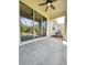 Spacious screened patio with sliding glass doors and ceiling fan at 761 Tremont Greens Ln # 61, Sun City Center, FL 33573