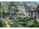 Landscaped backyard with seating area and mature trees at 811 Woodcarver Ln, Brandon, FL 33510