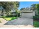 House exterior showcasing a two-car garage and well-maintained lawn at 811 Woodcarver Ln, Brandon, FL 33510