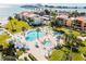 Aerial view of resort-style pool and spa with surrounding lounge chairs and lush landscaping at 851 Bayway Blvd # 104, Clearwater Beach, FL 33767