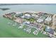 Aerial view of waterfront community with marina, pool, and tennis courts at 851 Bayway Blvd # 104, Clearwater Beach, FL 33767