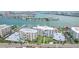 Aerial view of a condo building and parking lot near the waterfront at 851 Bayway Blvd # 104, Clearwater Beach, FL 33767