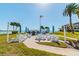 Community grilling area with picnic tables and umbrellas near the beach at 851 Bayway Blvd # 104, Clearwater Beach, FL 33767
