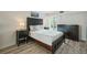 Bedroom with a bed, nightstands, and dresser at 851 Bayway Blvd # 104, Clearwater Beach, FL 33767