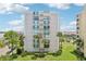 Building exterior showcasing the architectural design and landscaping at 851 Bayway Blvd # 104, Clearwater Beach, FL 33767