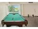 Pool table in a bright game room with balcony access at 851 Bayway Blvd # 104, Clearwater Beach, FL 33767