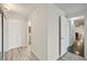 Clean hallway with light walls and wood-look floors at 851 Bayway Blvd # 104, Clearwater Beach, FL 33767