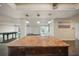 Open kitchen with granite island, looking toward living room at 851 Bayway Blvd # 104, Clearwater Beach, FL 33767