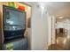 Stackable washer and dryer in a closet with hallway view at 851 Bayway Blvd # 104, Clearwater Beach, FL 33767