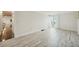 Spacious living room with wood-look floors and balcony access at 851 Bayway Blvd # 104, Clearwater Beach, FL 33767