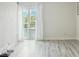 Bright living room with wood-look floors and patio doors at 851 Bayway Blvd # 104, Clearwater Beach, FL 33767